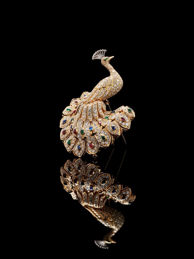 A diamond, sapphire, ruby and emerald peacock brooch by Cartier